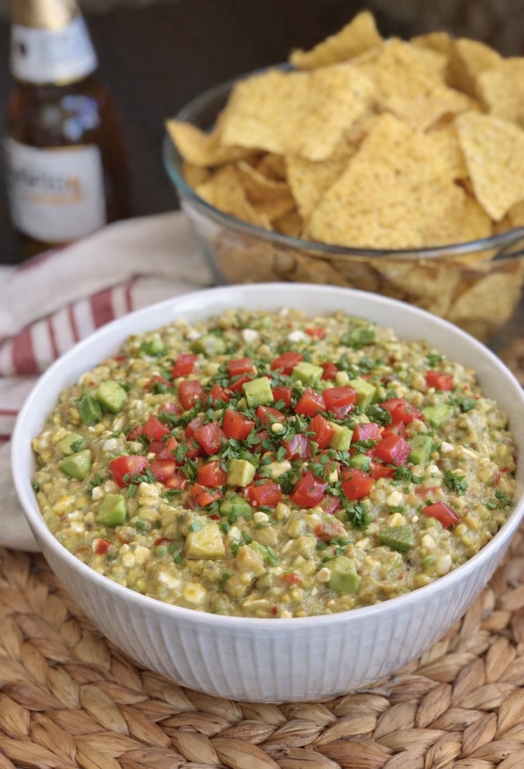 A big bowl full of a delicious and healthy appetizer that is made with just avocado, cottage cheese, salsa, and garlic. 