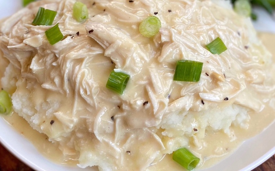 Easy shredded chicken and gravy recipe made in a slow cooker with just a few simple ingredients.