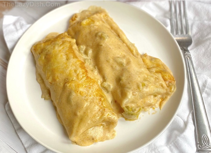 Easy Creamy White Chicken Enchiladas -- Made with rotisserie chicken! A quick and easy family dinner recipe. My picky kids love this simple weeknight meal!