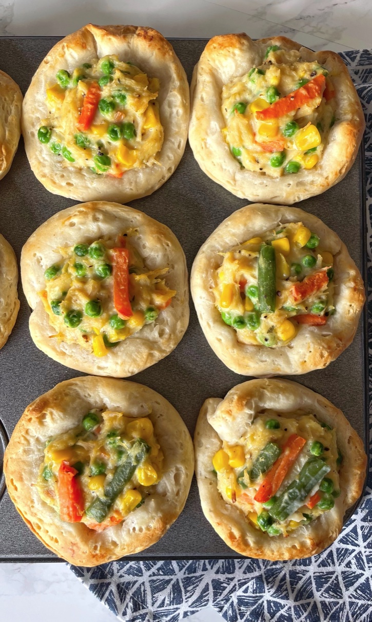 Cheap and easy family dinner idea! These muffin tin chicken pot pies are perfect for a family with picky kids. I make them often on busy school nights, or anytime I'm not in the mood to be in the kitchen all night cooking. The canned chicken and Pillsbury biscuits make them effortless! 