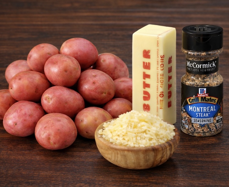 Red potatoes, a stick of butter, a bowl of parmesan cheese, and a yummy seasoning mixture to make butter swim roasted potatoes for dinner. 