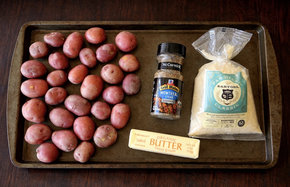 Ingredients needed for making butter swim potatoes including mini red potatoes, butter, parmesan, and seasoning.