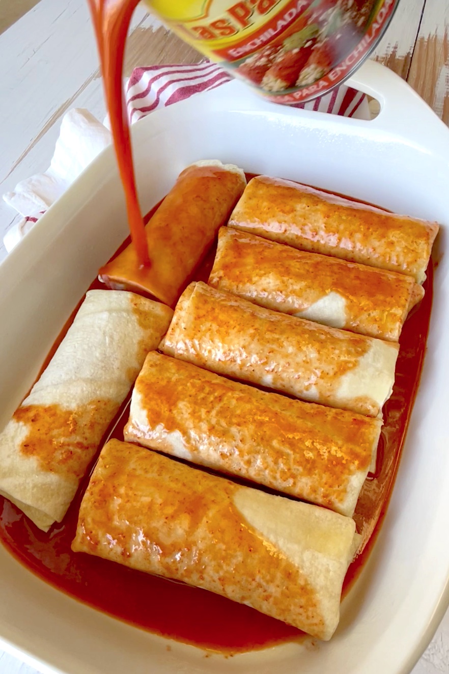 How to make frozen burritos way better! Turn them into an enchilada casserole. A great quick and easy dinner recipe for a family with kids! This simple meal is cheap to make and so effortless on busy weeknights when you don't feel like cooking. 