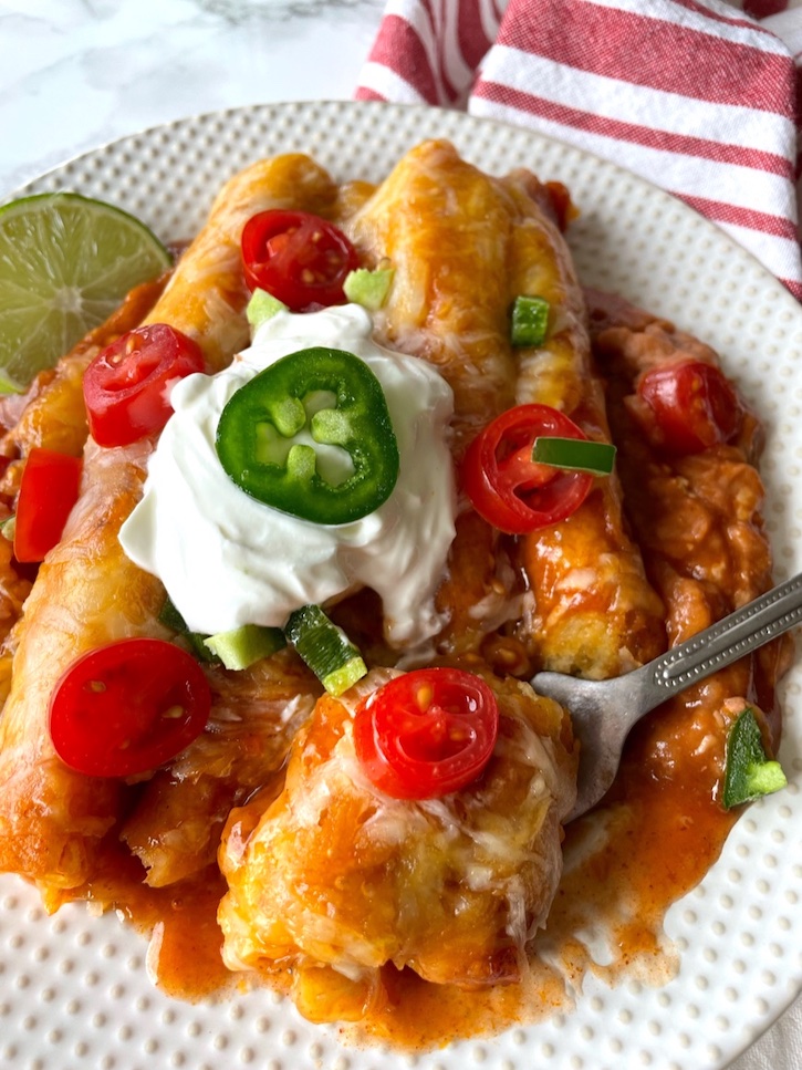 The easiest dinner in the world! Frozen Taquito Enchiladas! This one pan meal is my favorite dinner for busy weeknights. It's so easy to make you can do it with your eyes closed. 