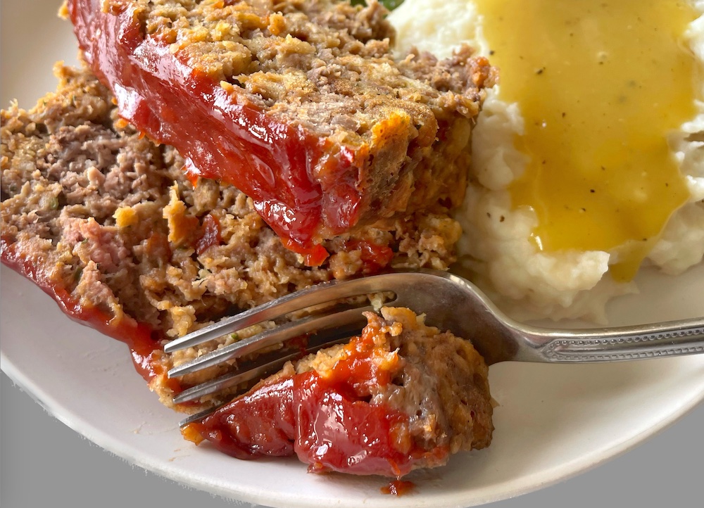 The best ever meatloaf made with a box of stove top stuffing! This family friendly meal is cheap to make with just a few ingredients, and is a hit with my family. Even my picky eaters gobble it up.