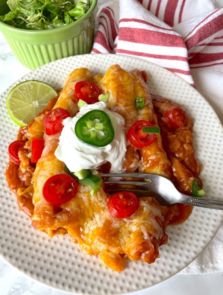 Lazy Enchiladas! This frozen taquito casserole bake is super quick and easy to make, and your picky family will love it! My kids devour it. It's perfect for a large family, but the leftovers are just as good so you can get two or more meals out of it. This is my favorite cooking hack, especially for busy school nights when I'm too tired to cook and clean. Only one dish required!