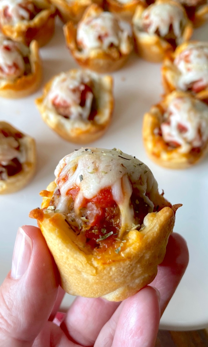 Are you looking for fun dinner ideas for kids? You can't go wrong with these mini meatball cupcakes! They are cheap and easy to make with just a few simple ingredients in a mini muffin tin including Pillsbury dough, frozen meatballs, pizza sauce and shredded mozzarella cheese! So simple and delicious for busy weeknight meals with the family. 