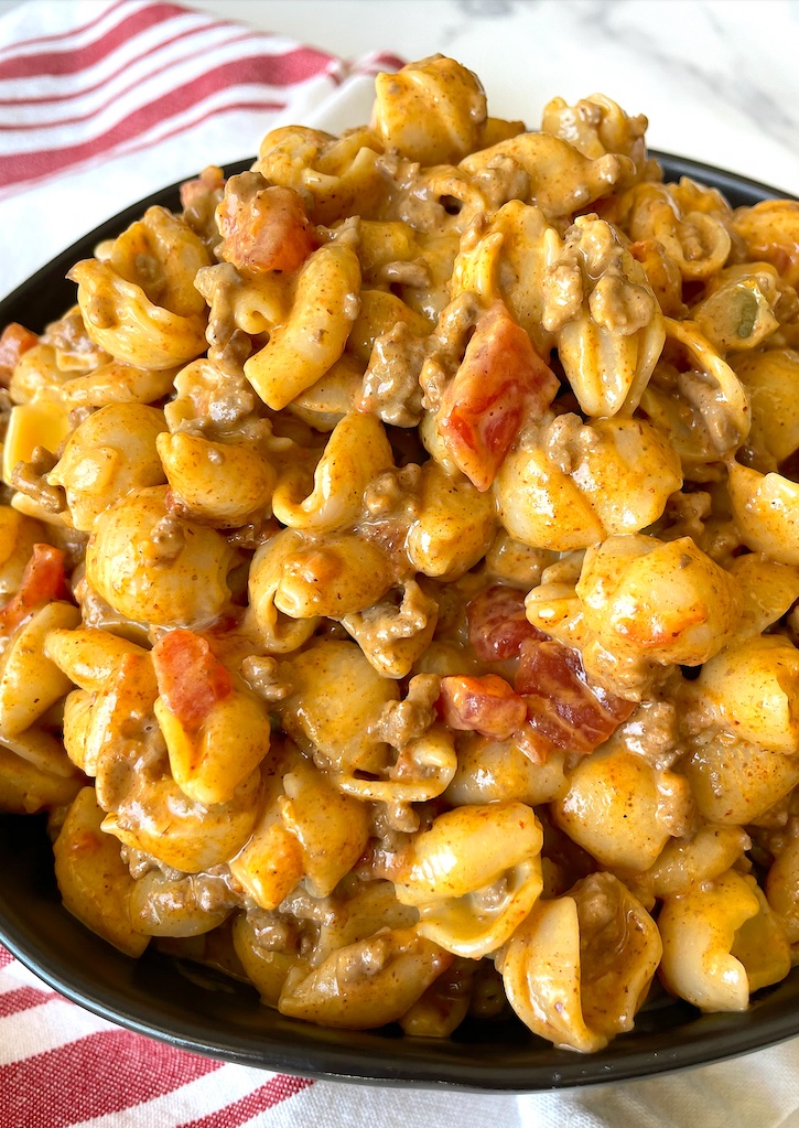The BEST ground beef dinner recipe! This taco macaroni and cheese dish is a family favorite meal for busy weeknights. It makes enough for a large family and is great leftover, plus it's budget friendly! These cheap ingredients are full of flavor. You don't need anything fancy to make a meal your family will ask you to make again and again. 