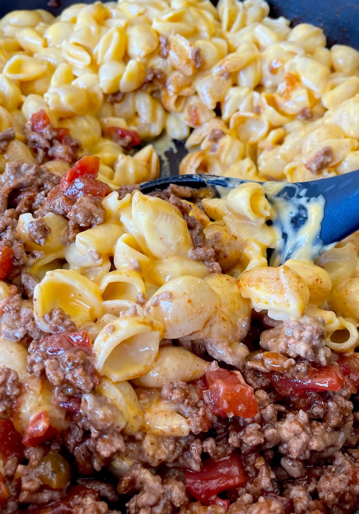 Are you looking for comfort food ideas to impress your family? My kids go nuts for this Taco Macaroni and Cheese Dinner! Just combine seasoned ground beef with your favorite boxed macaroni and cheese. We prefer Velveeta, but any of them are a great choice! My picky eaters love anything and everything pasta, and this main dish is by far their favorite. 