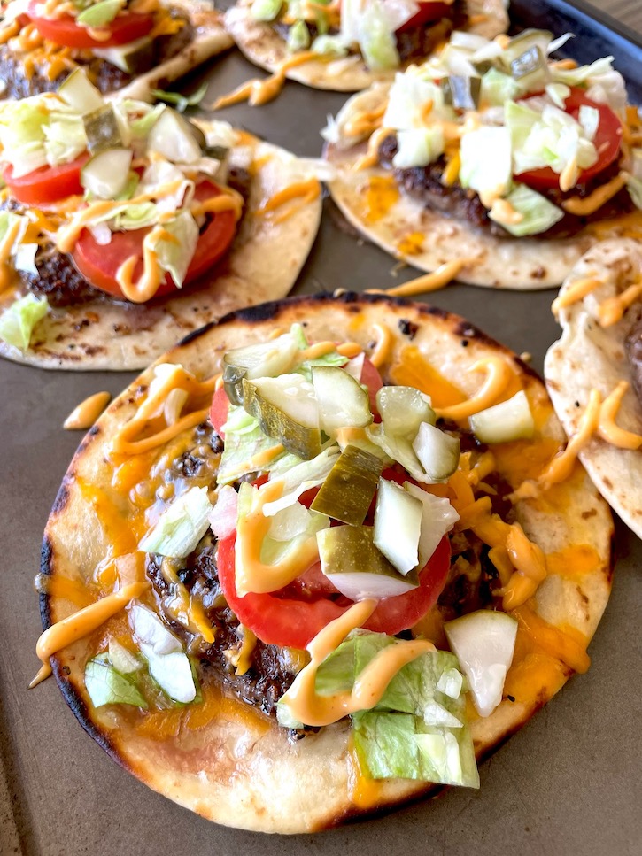 Smash burger tacos are a fun and easy dinner idea combining classic cheeseburger ingredients but replacing the bun with crispy flour tortillas to make tacos. 