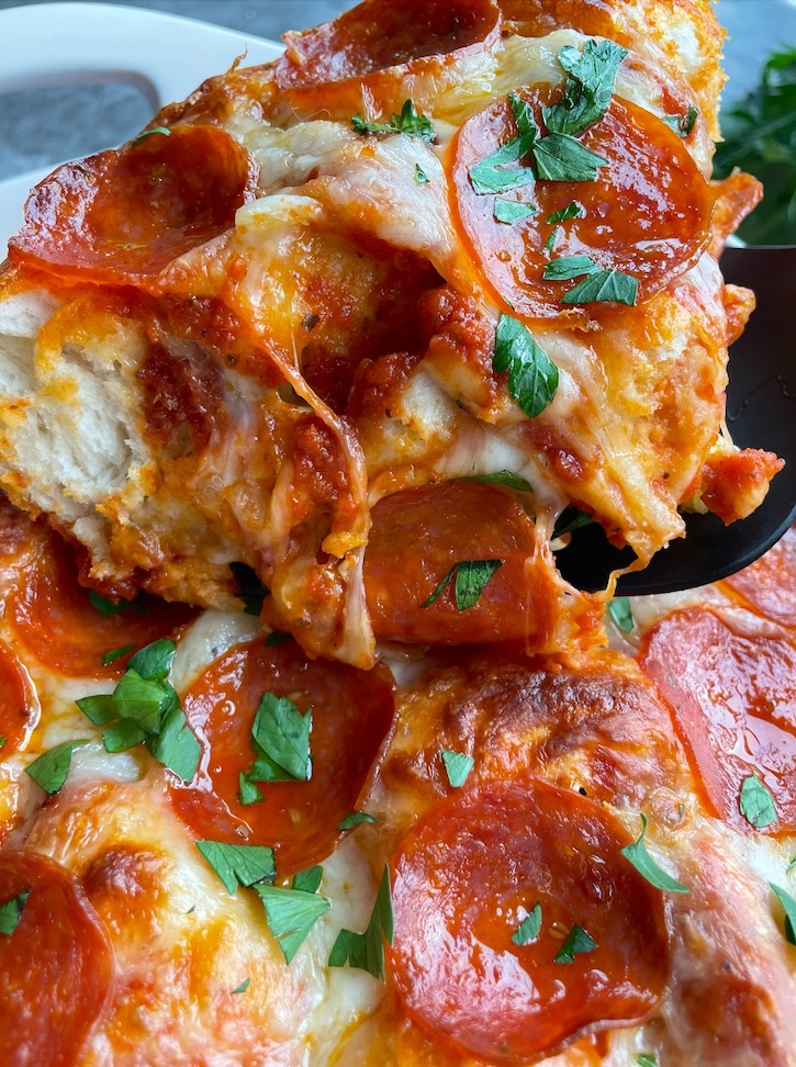 Close up of a pepperoni pizza biscuit casserole! An easy last minute dinner for a family with picky eaters. Kids love pizza, and busy moms love making this fast and effortless meal. 