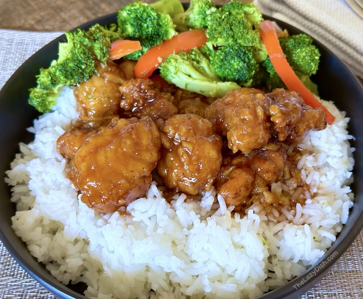 Simple and fast dinner idea for one or the entire family. Using only 5 ingredients you can make the best orange chicken at home as a quick meal when time is short. frozen chicken and minute rice make this meal extra lazy too!