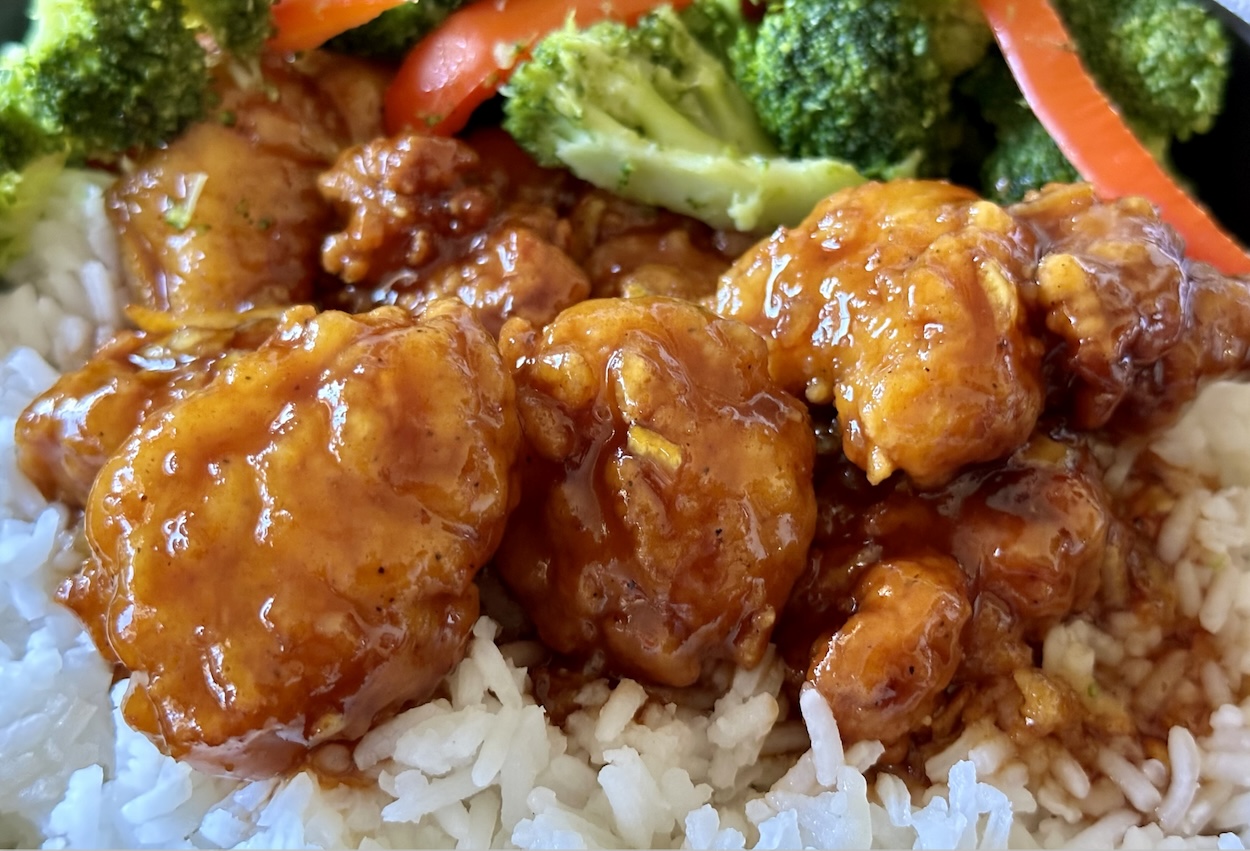 This easy popcorn chicken with a homemade orange sauce is so delicious. Using just a few ingredients you can make authentic tasting orange chicken and rice at home. This is an easy weeknight meal for busy families.