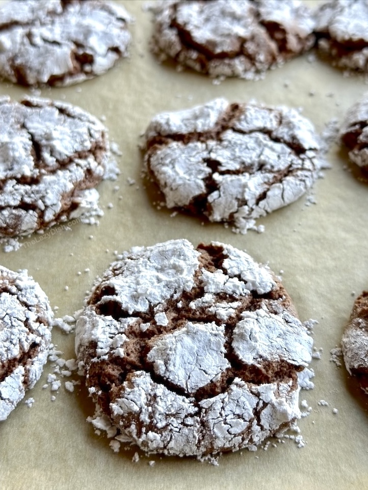 Easy fudgy chocolate cookies made with just 3 ingredients including Cool Whip, a box of cake mix, and powdered sugar. 