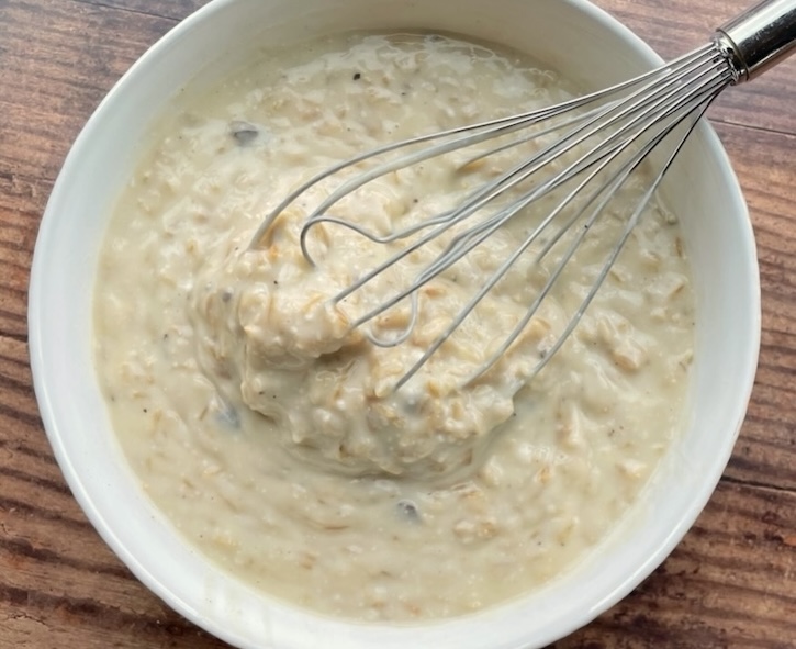 Instant rice and a few cans of cream soup mixed together in a bowl to make a creamy chicken dinner casserole. 