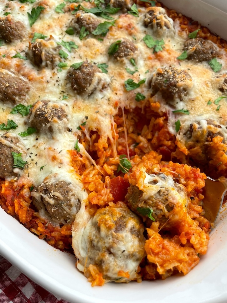 Cheesy meatballs on top of a tomato sauce and rice mixture to make a delicious family meal for busy school nights. Perfect for a large family with picky kids to feed!