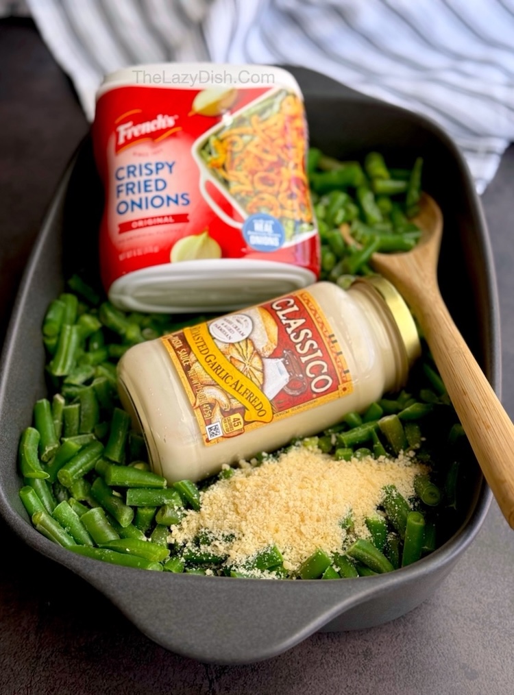 The best yummy green bean casserole veggie side dish for dinner made with a store bought jar of Alfredo sauce, parmesan cheese, and frozen green beans. And don't forget the delicious crispy French fried onions! So simple to make for a family of 6 but you can double the recipe if you're feeding a crowd. 