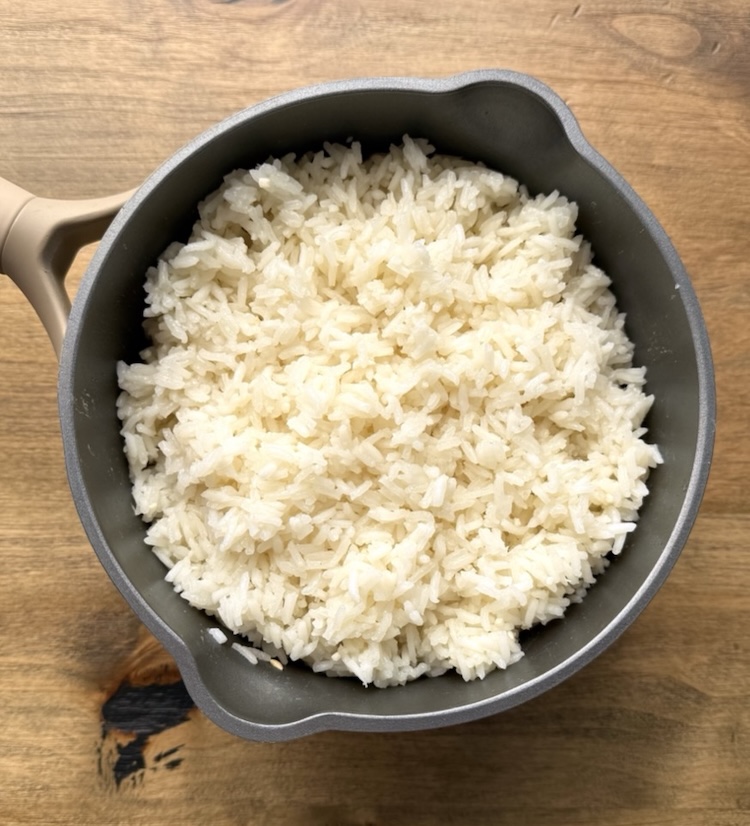 Fluffy white rice in a small pan ready to be served. 