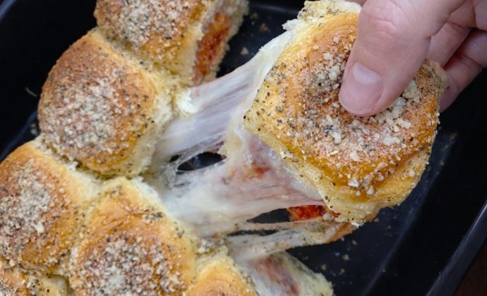 Easy homemade meal made with any brand of frozen chicken nuggets, Hawaiian rolls, marinara or pizza sauce, cheese, and garlic butter.