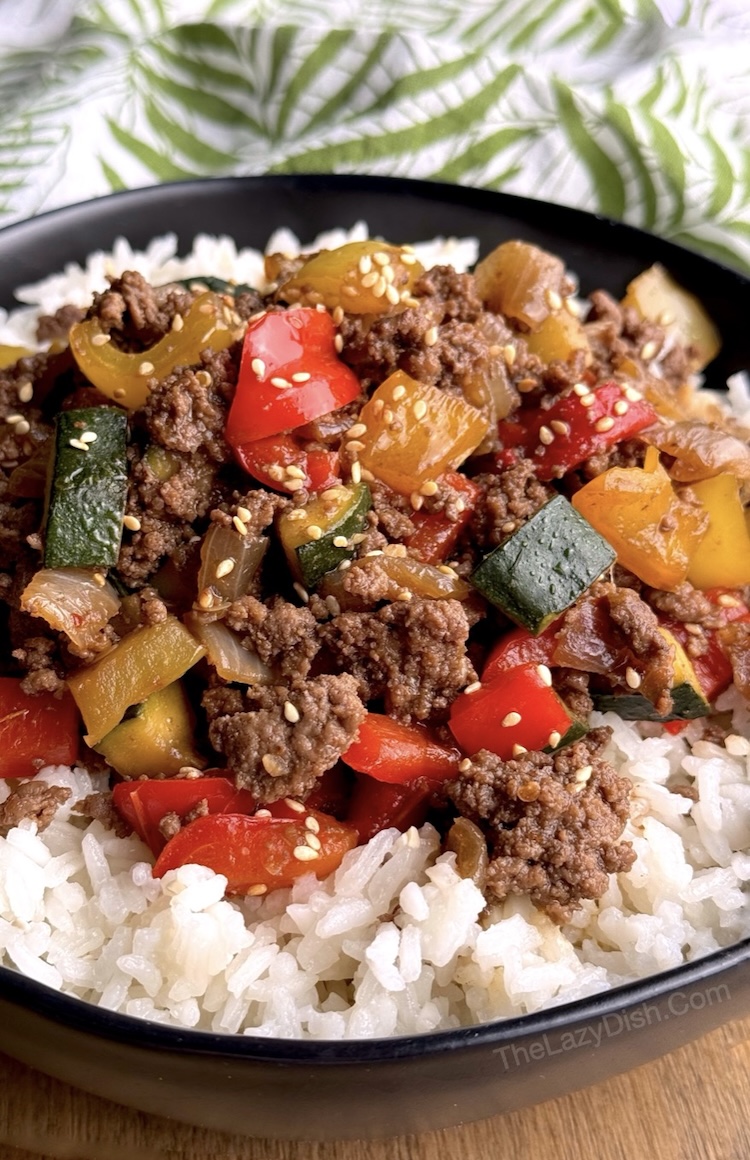 Close up view of a bowl of rice topped with a sweet and savory mixture of ground beef and bell peppers tossed in soy sauce and brown sugar sauce. 