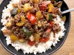 Asian style ground beef and bell pepper stir fry over white rice in a simple homemade sauce.