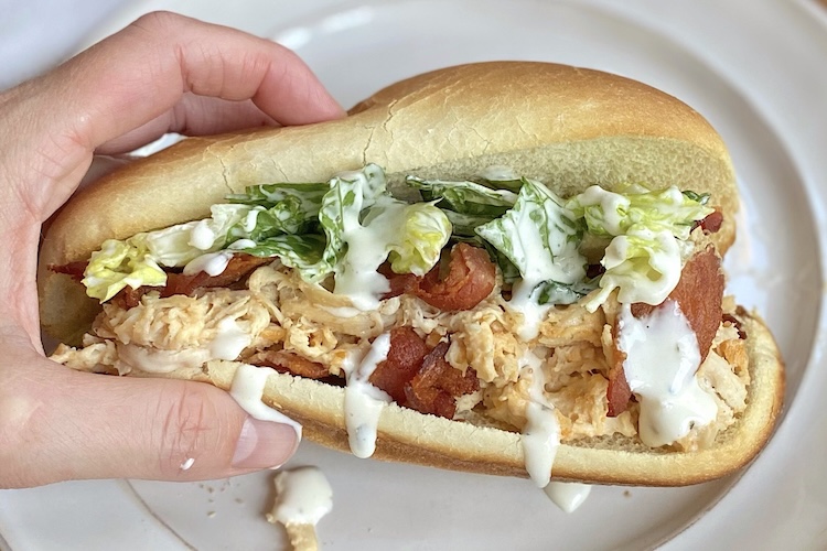 Creamy chicken sandwich with ranch dressing, bacon, and lettuce, in a toasted hoagie roll. 